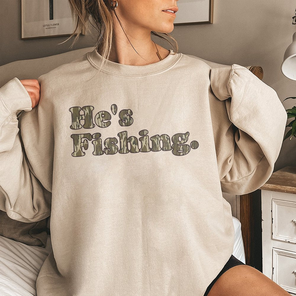 He's Fishing Sweatshirt | Camo Lettering Graphic Print | Soft Cotton-Blend Premium Apparel | Gift for Angler Fisherman Outdoo